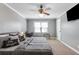 Comfortable bedroom featuring a ceiling fan, carpeted floors, desk, and a mounted flat screen TV at 1123 Seaboard Nw Ave, Atlanta, GA 30318