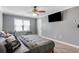Relaxing bedroom featuring grey walls, carpeted floors, a ceiling fan, and a mounted flat screen TV at 1123 Seaboard Nw Ave, Atlanta, GA 30318
