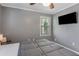 Cozy bedroom featuring grey walls, carpeted floors, a ceiling fan, and a mounted flat screen TV at 1123 Seaboard Nw Ave, Atlanta, GA 30318