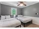 Comfortable bedroom featuring two twin beds, neutral gray walls, and a classic ceiling fan at 1123 Seaboard Nw Ave, Atlanta, GA 30318