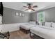 Charming bedroom with two twin beds, gray walls, ceiling fan, and decorative wall art at 1123 Seaboard Nw Ave, Atlanta, GA 30318