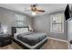 Comfortable bedroom with gray walls, carpeted floors, a ceiling fan, and a mounted flat screen TV at 1123 Seaboard Nw Ave, Atlanta, GA 30318