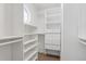 Organized walk-in closet with white shelving and a unique round window for natural light at 1123 Seaboard Nw Ave, Atlanta, GA 30318