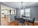 Inviting dining area with modern chandelier and pass-through to updated kitchen, great for entertaining at 1123 Seaboard Nw Ave, Atlanta, GA 30318