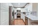 Modern kitchen featuring stainless steel appliances, white cabinets, and marble countertops at 1123 Seaboard Nw Ave, Atlanta, GA 30318