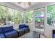 Relaxing patio with wicker furniture, blue cushions, screened windows, and an outdoor grill, perfect for entertaining at 1123 Seaboard Nw Ave, Atlanta, GA 30318