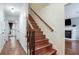 Elegant staircase features wood steps, decorative iron spindles, and a wood handrail, connecting to a hardwood hallway at 1123 Seaboard Nw Ave, Atlanta, GA 30318