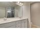 Bathroom with double vanity, white cabinets, and a large mirror at 616 Leafy Branch Way, Mcdonough, GA 30253