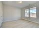 Bright bedroom with neutral walls, light wood floors, and large windows offering a pleasant view at 616 Leafy Branch Way, Mcdonough, GA 30253