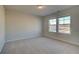 Cozy bedroom with neutral carpet, two windows and natural light at 616 Leafy Branch Way, Mcdonough, GA 30253