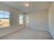 Well-lit bedroom with large windows, neutral paint, and new carpet at 616 Leafy Branch Way, Mcdonough, GA 30253
