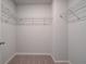Walk-in closet with shelving units and neutral carpeting, ready for organization at 616 Leafy Branch Way, Mcdonough, GA 30253