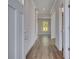 Inviting hallway with wood flooring, light gray walls, and white trim showcasing the home's interior at 616 Leafy Branch Way, Mcdonough, GA 30253