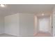 Well-lit hallway with neutral paint, recessed lighting and leading to multiple rooms at 616 Leafy Branch Way, Mcdonough, GA 30253