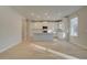 Modern kitchen with white cabinets, stainless steel appliances, and a large island, perfect for entertaining at 616 Leafy Branch Way, Mcdonough, GA 30253