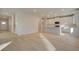 Open-concept living room flows into a bright, modern kitchen with white cabinets and an island at 616 Leafy Branch Way, Mcdonough, GA 30253
