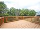 Wooden back deck overlooks lush greenery, creating a serene outdoor space for relaxation at 7586 Jennadee Dr, Fairburn, GA 30213