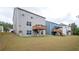 Rear exterior view of homes showcasing spacious backyards with wooden decks overlooking green space at 7586 Jennadee Dr, Fairburn, GA 30213