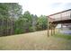 Expansive backyard featuring a wooden deck overlooking a lush, green space with mature trees at 7586 Jennadee Dr, Fairburn, GA 30213