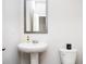 Pedestal sink in a bathroom with a large mirror and white walls at 7586 Jennadee Dr, Fairburn, GA 30213