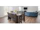 Dining room features modern wood table with seating for six, adjacent to the living room at 7586 Jennadee Dr, Fairburn, GA 30213