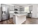 Bright eat-in kitchen with an island, stainless appliances, and gray cabinets at 7586 Jennadee Dr, Fairburn, GA 30213
