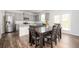 Modern eat-in kitchen with stainless steel appliances, granite countertops, and wood floors at 7586 Jennadee Dr, Fairburn, GA 30213