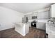 Modern kitchen features an island, stainless appliances, and light gray cabinets at 7586 Jennadee Dr, Fairburn, GA 30213
