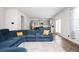 Open concept living room with a kitchen view and a large blue sofa at 7586 Jennadee Dr, Fairburn, GA 30213