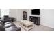 Cozy living room with a plush sofa, accent chair, and sleek entertainment unit at 7586 Jennadee Dr, Fairburn, GA 30213