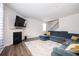 Cozy living room with fireplace and a comfortable, oversized blue sofa at 7586 Jennadee Dr, Fairburn, GA 30213
