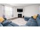 Comfortable living room with fireplace and a blue sectional sofa at 7586 Jennadee Dr, Fairburn, GA 30213