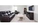 Comfortable living room with a large leather sofa, recliner, and entertainment center at 7586 Jennadee Dr, Fairburn, GA 30213