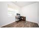 Home office features wood floors, a desk with dual monitors, and natural light at 7586 Jennadee Dr, Fairburn, GA 30213