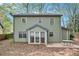 Home exterior showing a green siding, patio and partially-wooded backyard at 835 Ridge Ave, Stone Mountain, GA 30083