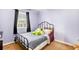 Cozy bedroom features a window, soft carpet, and a bed with a metal frame at 835 Ridge Ave, Stone Mountain, GA 30083