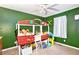 Cozy bedroom featuring a unique bed frame, green walls, and soft carpet at 835 Ridge Ave, Stone Mountain, GA 30083