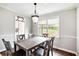 Elegant dining room featuring a stylish light fixture and a view of the backyard at 835 Ridge Ave, Stone Mountain, GA 30083