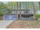 Inviting two-story home with a covered front porch and a convenient two-car garage at 835 Ridge Ave, Stone Mountain, GA 30083