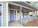 Inviting front porch featuring lattice railing, seating, and a charming entry door at 835 Ridge Ave, Stone Mountain, GA 30083