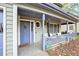 Cozy covered front porch with seating area and decorative railing at 835 Ridge Ave, Stone Mountain, GA 30083