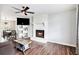 Spacious living room with a fireplace, ceiling fan, and open access to the dining area at 835 Ridge Ave, Stone Mountain, GA 30083