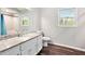 Main bathroom with wood-style floors, white walls, granite countertop, and bath-shower combo at 835 Ridge Ave, Stone Mountain, GA 30083