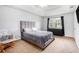 Spacious main bedroom features a tray ceiling, soft carpet, neutral walls, and a large window at 835 Ridge Ave, Stone Mountain, GA 30083