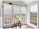 Sunroom featuring many windows, hardwood-style floors and access to the backyard at 835 Ridge Ave, Stone Mountain, GA 30083