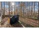 A wooden deck surrounded by trees with a grill at 184 Chamberlyn Ln, Hiram, GA 30141