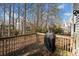 A wooden deck with a grill, surrounded by trees at 184 Chamberlyn Ln, Hiram, GA 30141