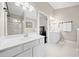 Bright bathroom featuring double sink vanity, mirror, and glass shower with white walls and tile floor at 184 Chamberlyn Ln, Hiram, GA 30141