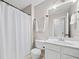 Clean bathroom featuring a single sink vanity, mirror, and shower with white walls and a tile floor at 184 Chamberlyn Ln, Hiram, GA 30141