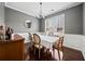 Bright dining room with hardwood floors, wainscoting, a chandelier, and a large window at 184 Chamberlyn Ln, Hiram, GA 30141